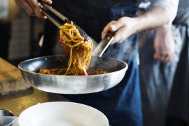 Chef cooking spaghetti in the kitchen